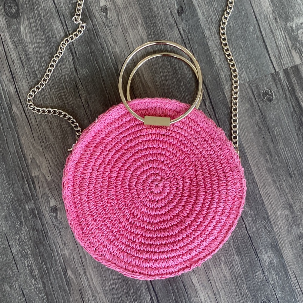 Round, pink straw purse with gold hardware